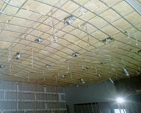 CSR Bradford Gold batts installed over grid in large auditorium.