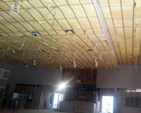 CSR Bradford Gold batts installed over grid with Soundscreen visible in walls behind. 
