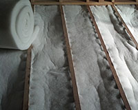 Bulk polyester insulation installed between joists.