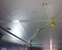 Dow Thermax PIR insulation board direct fixed to concrete slab – temporary power lines held up with insulation fasteners.