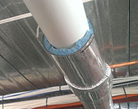 Pipe lagging being installed – cutaway view shows Soundlag 4525C foam inner (blue) and high density outer layer (silver). Extremely effective noise attenuation.