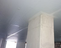 Dow Thermax PIR insulation board direct fixed to concrete slab – white face of board is visible.