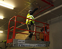 Using scissor lift to tape CSR Xtratherm boards at height.